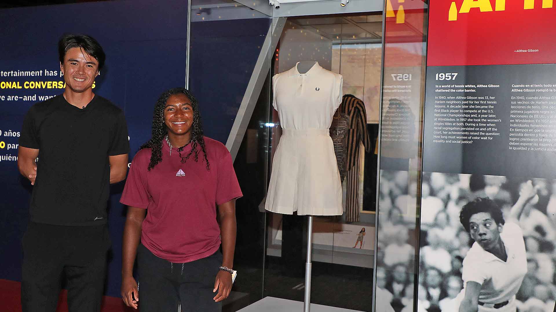 Taro Daniel and Hailey Baptiste pose with Althea Gibson's 1957 Wimbledon kit at the National Museum of American History.