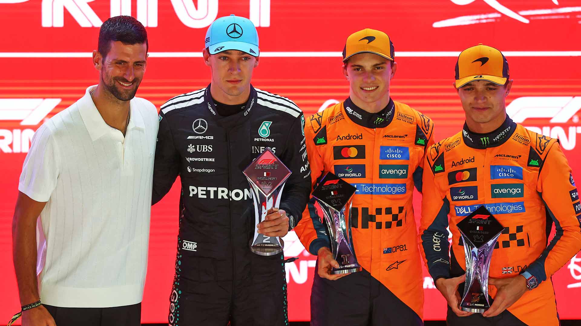 Novak Djokovic poses for a photo with George Russell, Oscar Piastri and Lando Norris on Saturday.
